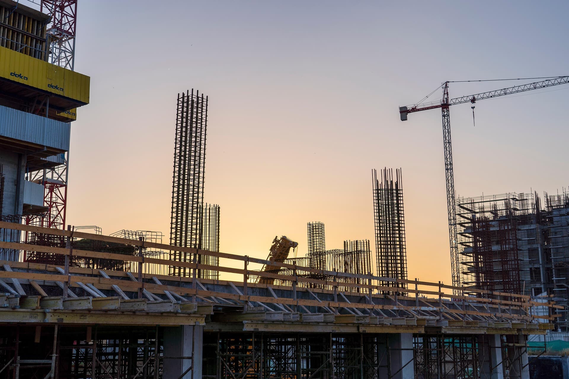 A construction site at sunset in a fast-growing town